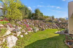 View of grassy yard with a patio