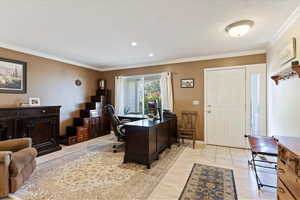 Office area featuring crown molding and light wood-style floors
