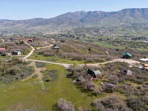 Aerial view of property and surrounding area with a mountainous background