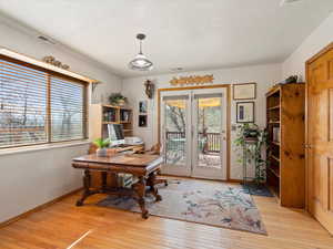 Home office featuring light wood finished floors and baseboards