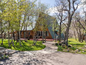 A-frame home with a front lawn