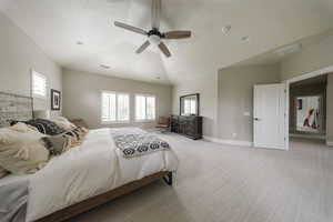 Bedroom featuring light colored carpet, multiple windows, a ceiling fan, baseboards, and vaulted ceiling