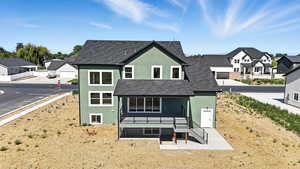Rear view of house featuring stucco siding and a residential view