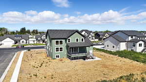 Back of house with a residential view, a shingled roof, and stucco siding