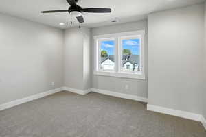 Unfurnished room with carpet and ceiling fan