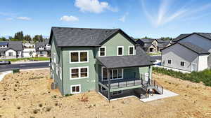 Rear view of house with a residential view, stucco siding, and a shingled roof