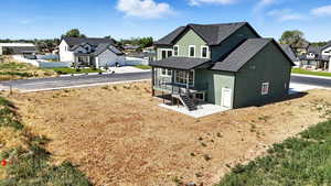 Back of property featuring stucco siding, a residential view, a shingled roof, and stairway