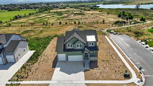 Aerial view of property and surrounding area with a large body of water
