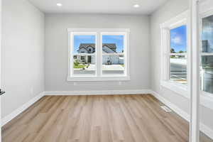 Featuring light wood-style floors and recessed lighting.