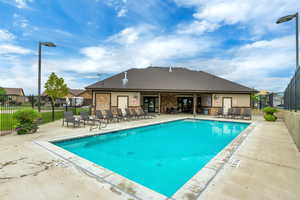 Community pool with fence and a patio area and Clubhouse