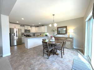 Dining area with a chandelier, baseboards, and recessed lighting