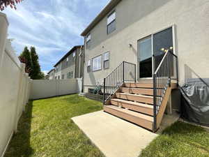 Rear view of house featuring stucco siding and a patio