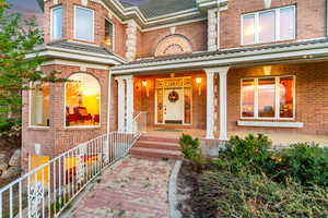 Property entrance with brick siding and covered porch