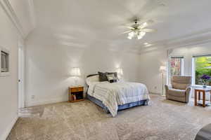 Bedroom with carpet flooring, crown molding, baseboards, and a ceiling fan