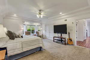 Bedroom featuring recessed lighting, ornamental molding, baseboards, carpet flooring, and a ceiling fan