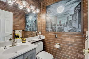 Bathroom featuring toilet, and vanity