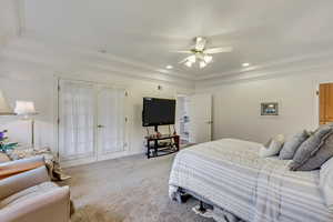 Carpeted bedroom featuring ornamental molding, ceiling fan, and recessed lighting