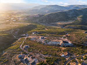 Aerial view of property and surrounding area with a mountainous background