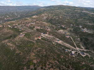 Aerial view of property and surrounding area with a mountain backdrop