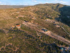 Aerial view of property's location featuring a mountainous background