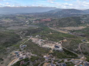 Aerial view of property and surrounding area featuring a mountain backdrop