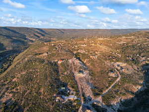 Aerial view of property and surrounding area with a mountain backdrop