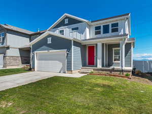View of front facade featuring board and batten siding, concrete driveway, an attached garage, and covered porch