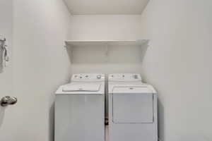 Washroom featuring washer and dryer