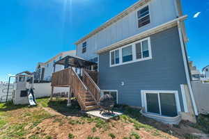 Back of house featuring board and batten siding, fence, a gazebo, and stairway
