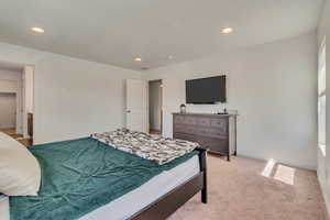 Bedroom featuring recessed lighting, light carpet, and baseboards