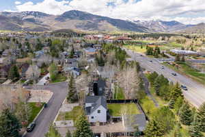 Aerial view of property's location featuring a mountain backdrop and nearby suburban area