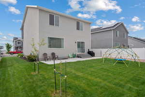 Back of property with a patio and a playground