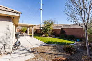 View of yard featuring a fenced backyard and a patio area with AstroTurf.