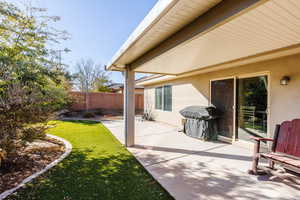View of patio / terrace with fence and area for grilling.