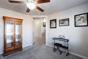 Interior space with ceiling fan and baseboards