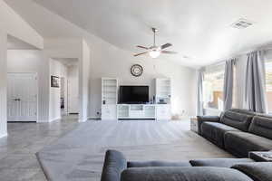 Living room featuring visible vents, ceiling fan, high vaulted ceiling, and baseboards