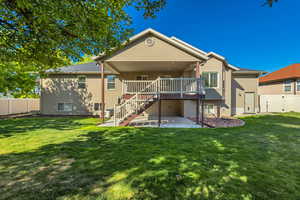 Rear view of property featuring a patio, stairway, and a deck