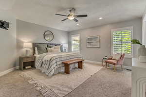 Bedroom with baseboards, light colored carpet, a textured ceiling, ceiling fan, and recessed lighting
