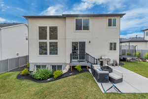 Back of property featuring a trampoline, stucco siding, a patio, and an outdoor living space