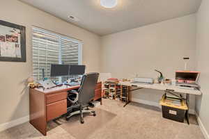 Carpeted office featuring baseboards