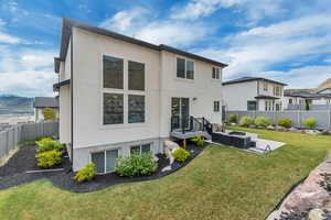 Back of property featuring stucco siding and an outdoor hangout area
