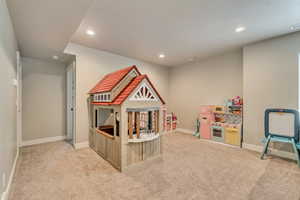Recreation room with light carpet, recessed lighting, baseboards, and a textured ceiling