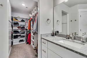 Bathroom with a spacious closet and vanity