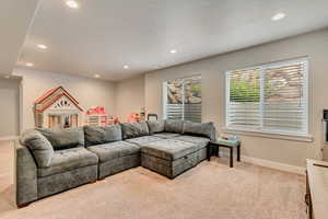 Living room featuring carpet flooring, recessed lighting, and baseboards