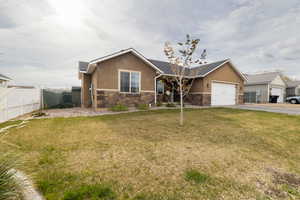Ranch-style home with stone siding, concrete driveway, an attached garage, and stucco siding