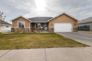 Ranch-style house with stone siding, a garage, stucco siding, concrete driveway, and a shingled roof