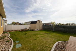View of yard with a storage shed and an outdoor structure
