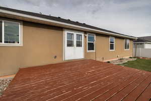 Wooden terrace featuring fence