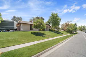View of front of home featuring a front lawn and brick siding
