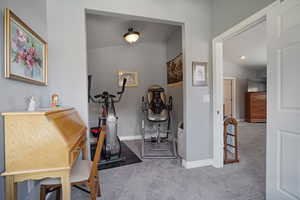 Upstairs Primary Suite Workout area with carpet flooring and baseboards